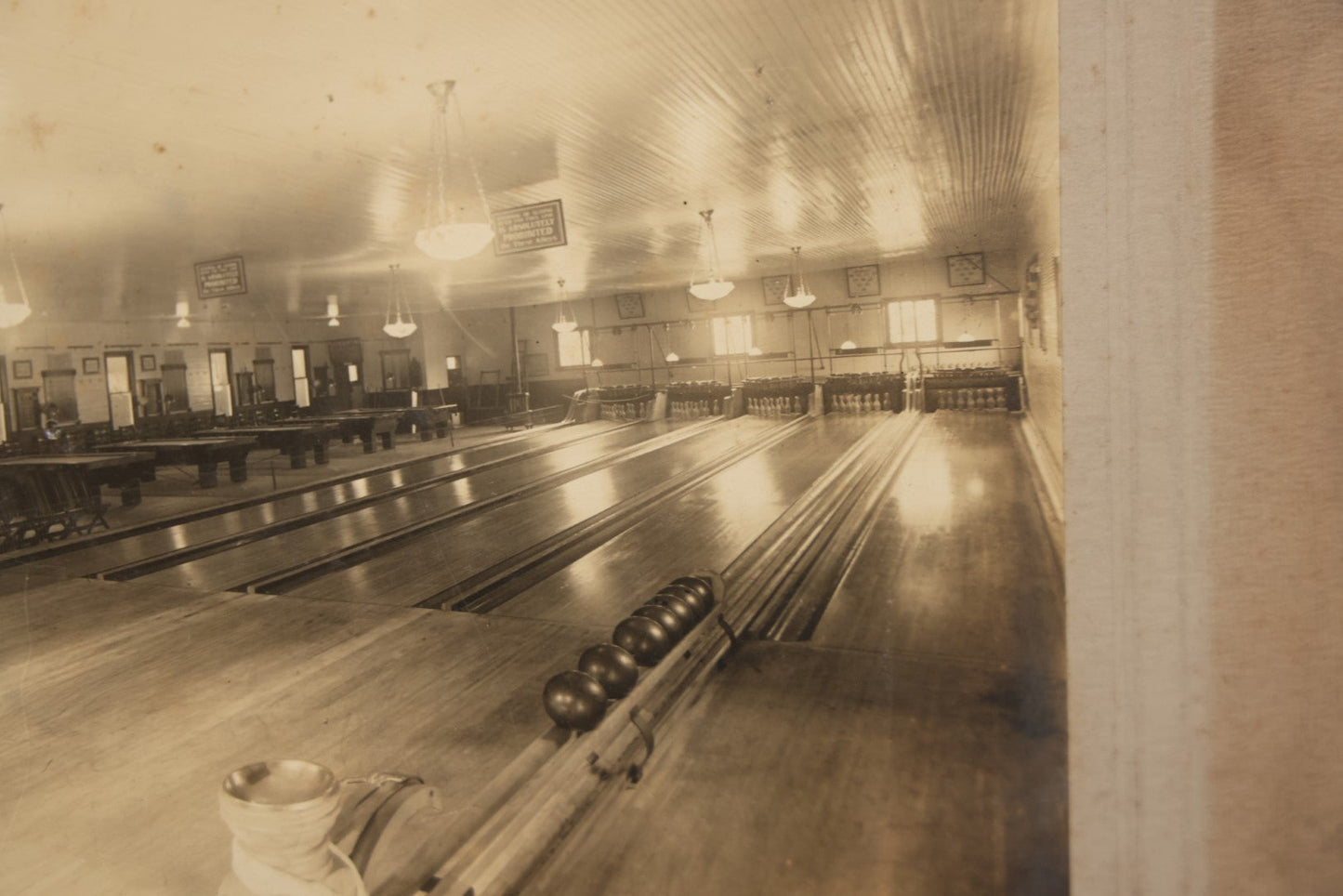 Lot 068 - Antique Boarded Occupational Photograph Of An Old Time Bowling Alley, With Man Behind Counter, Signage