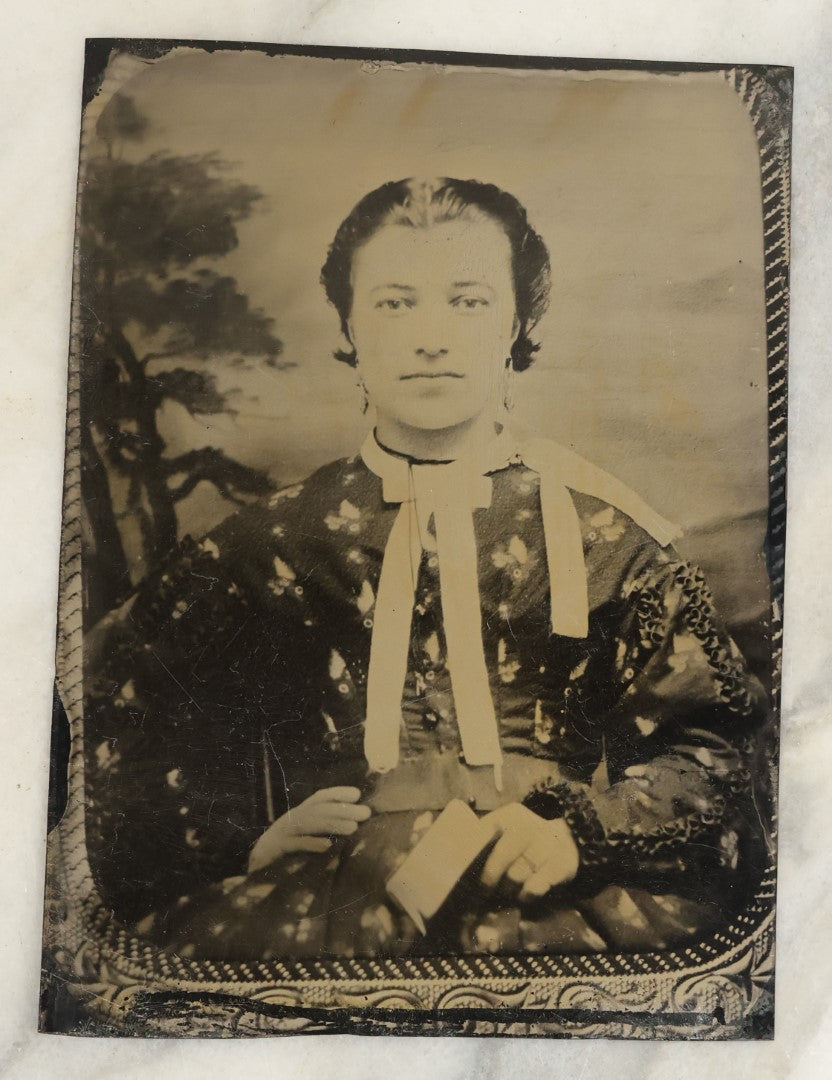Lot 119 - Pair Of Approximately Half Plate Tintypes Of A Man And Women, Likely A Couple, Note Woman Holding Small Book, One Lot One Money