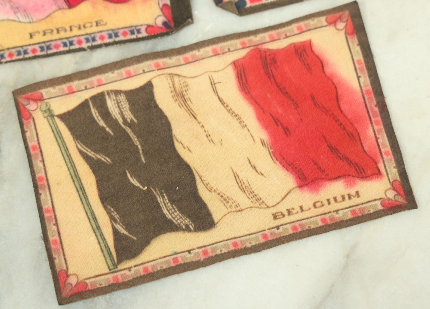 Lot 141 - Grouping Of Seven Antique Tobacco Felt Country Flags Including The United States Jack, France, Austria Hungary, Zion, Belgium, Germany, And France