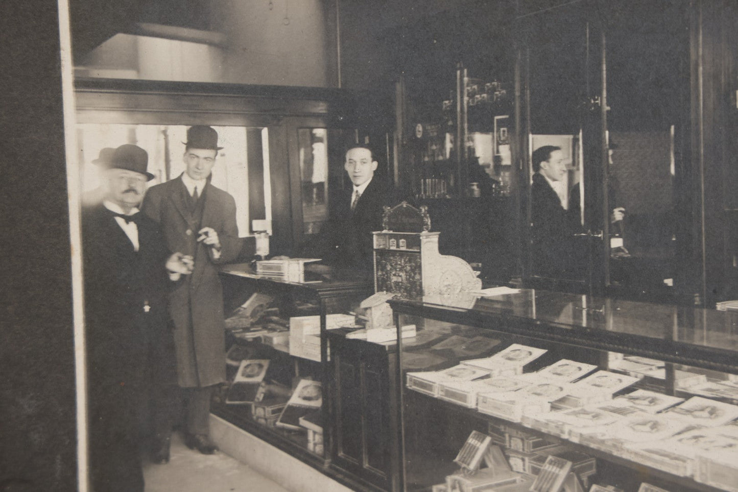 Lot 109 - Antique Boarded Photo Of A Tobacco, Cigar Shop, With Man Behind Counter, Customers In Bowler Hats, Various Cigar Brands