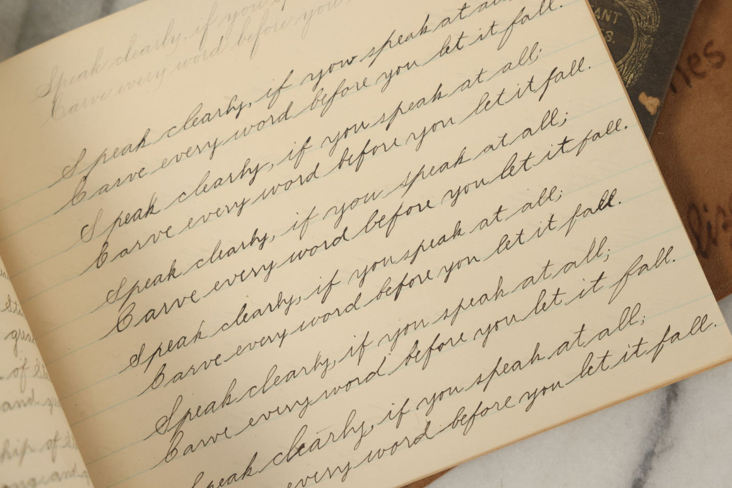 Lot 129 - Grouping Of Four Pieces Of Ephemera Including The Land Of The Pilgrim Fathers Book, Harper's Penmanship Book, Leather Blotter From Long Beach, California, And Infant Series Book