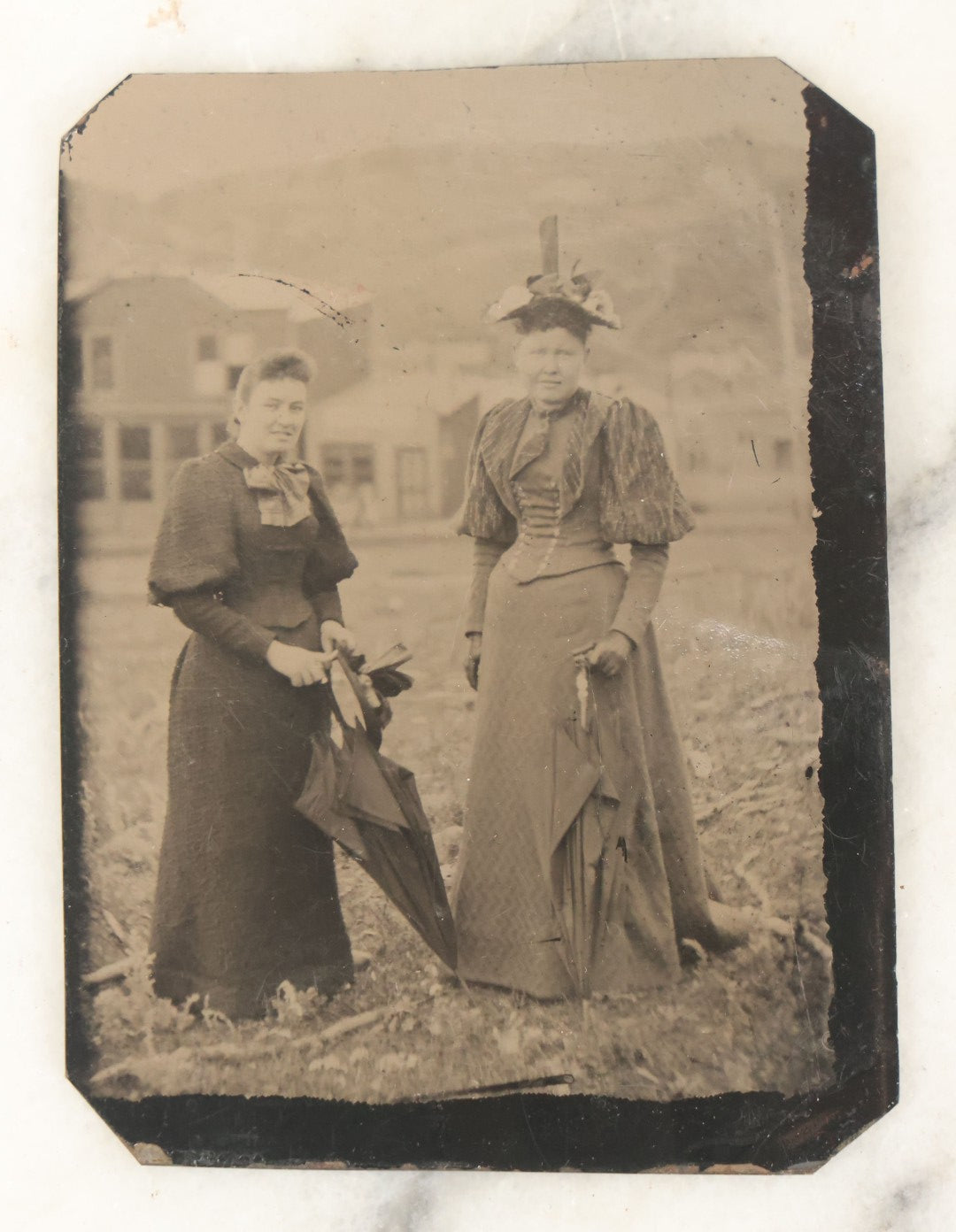 Lot 059 - Single Antique Tintype Photograph, Two Women Outdoors In Town Square, With Parasols