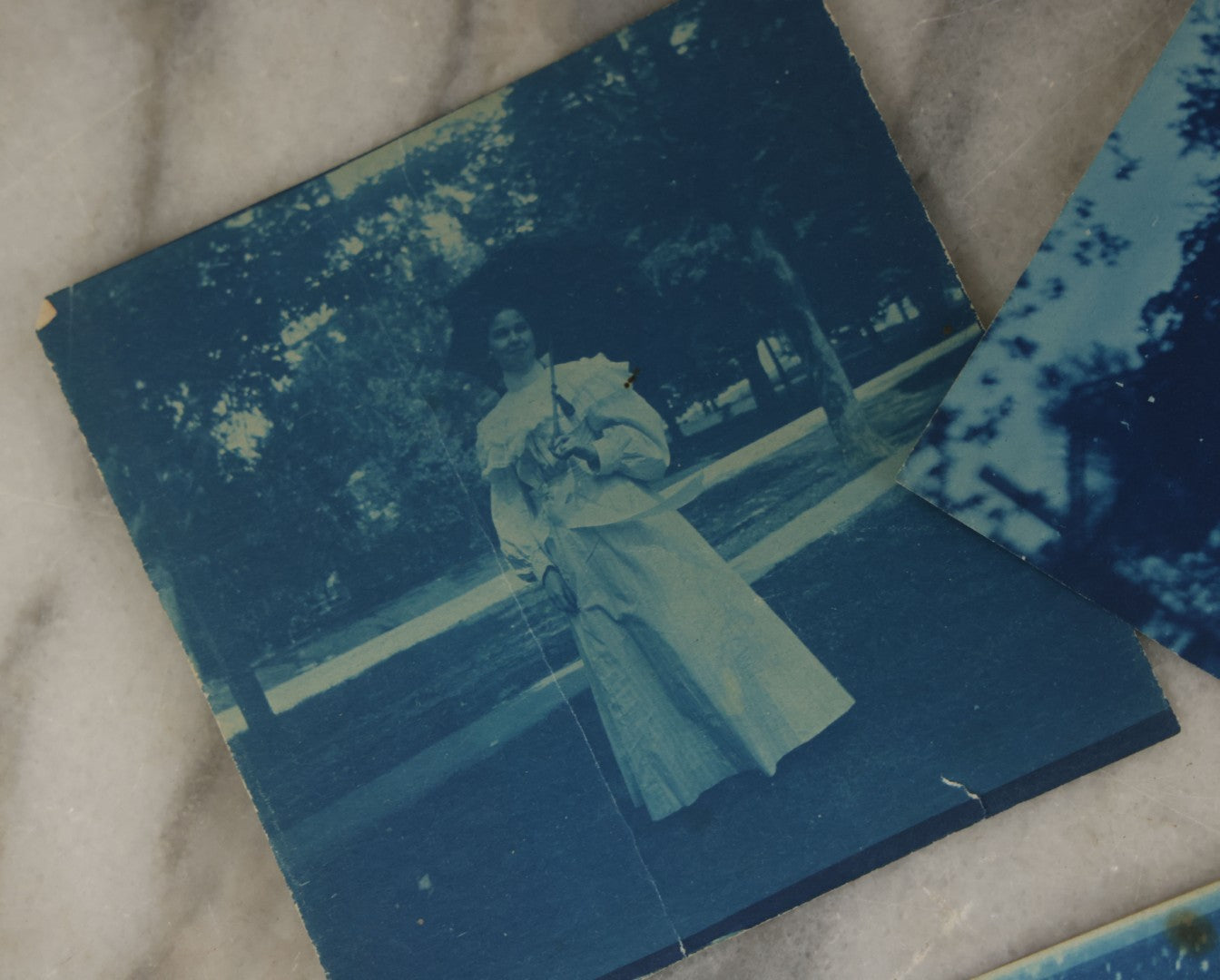 Lot 170 - Grouping Of 9 Snapshot Photographs Including 8 Cyanotypes Of Victorian Women And Children, Women With Bicycles, Skiing, Etc.