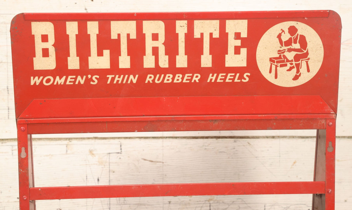 Lot 098 - Vintage Biltrite "Women's Thin Rubber Heels" Metal Shoe Repair Store Display, Red Advertising Shelf, "Get Longer Wear By Shoe Repair," Approximately 16" Wide, 17" Tall