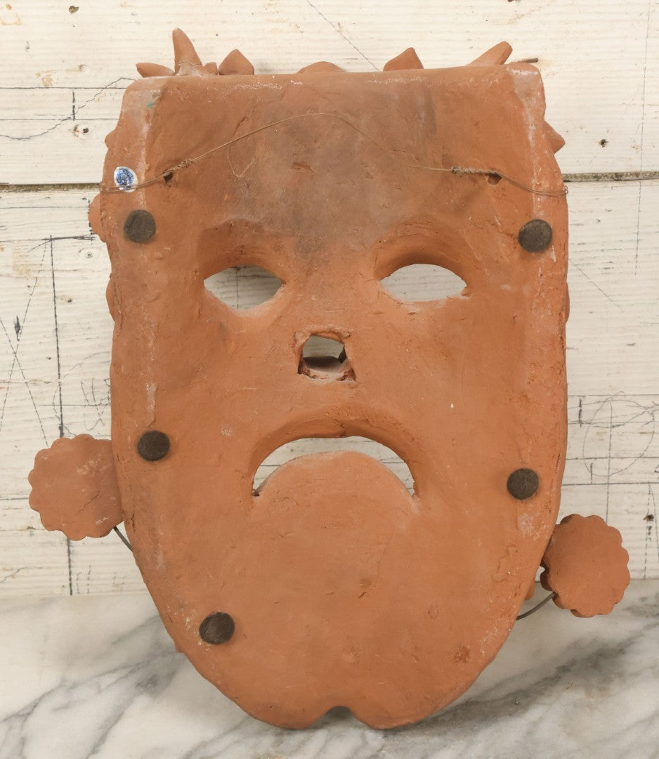 Lot 016 - Vintage Unpainted Red Clay Mexican Folk Art Mask, Made In Mexico Sticker On Verso, With Posable Wire Attached Adornments, With Wire Hanger