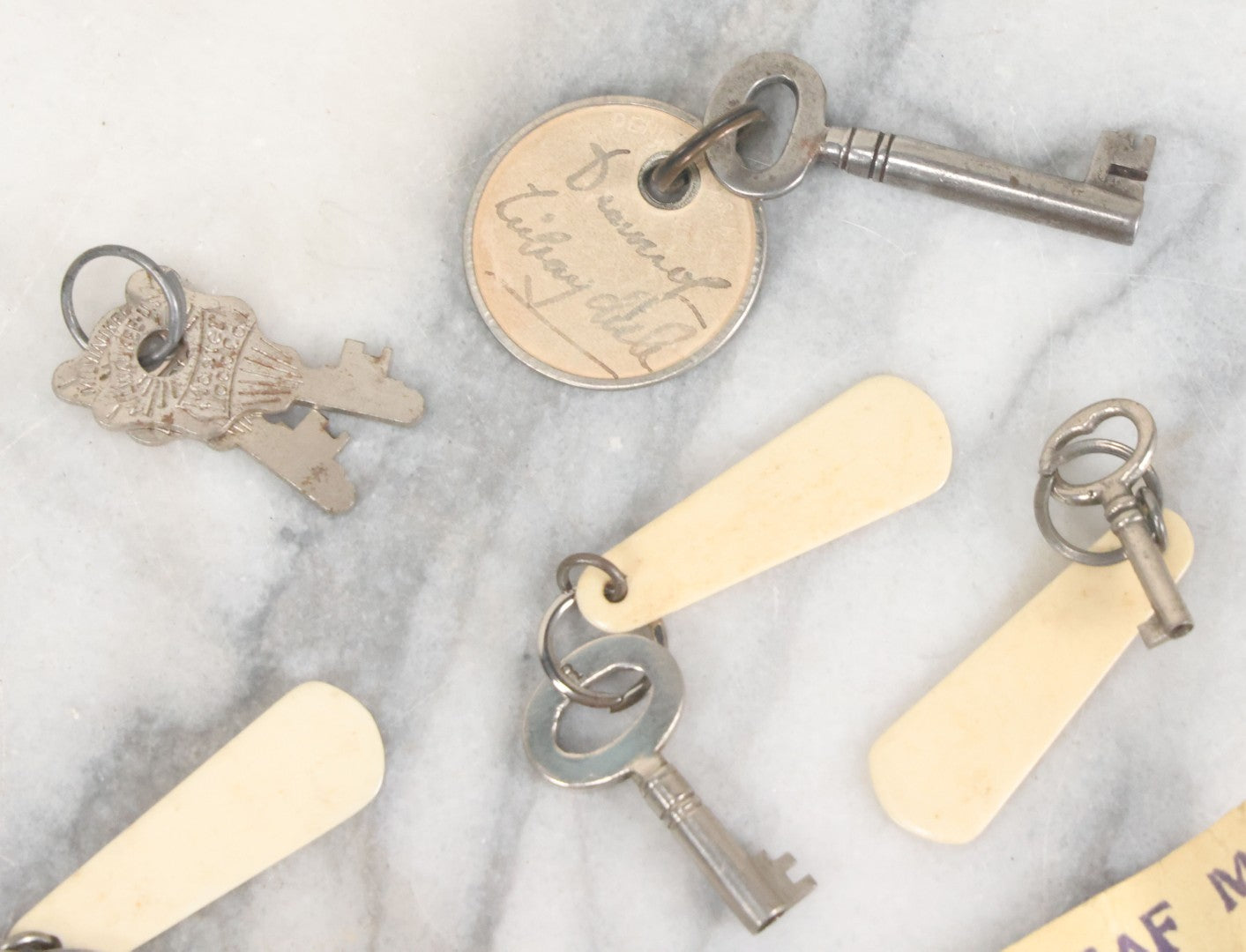 Lot 124 - Grouping Of 10+ Antique Furniture And Other Skeleton Keys With Custom Carved Bone Key Tag Keychains, Including Lucite Eagle Keychain Sold By A Deaf Mute Person