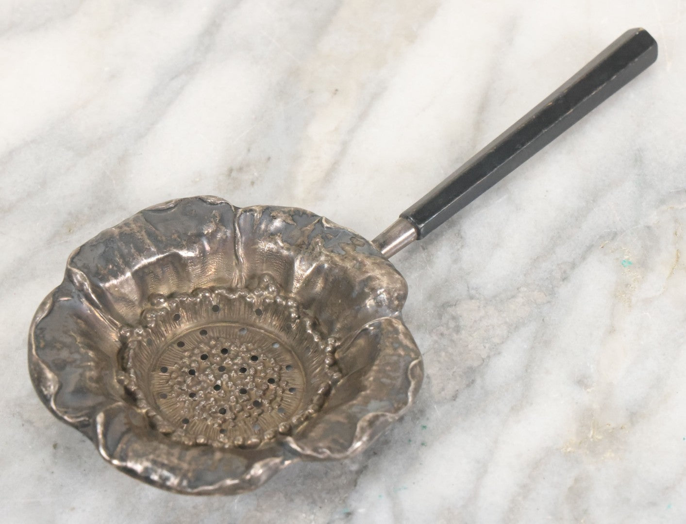 Lot 028 - Antique Sterling Silver Anemone Flower Tea Strainer With Octagonal Black Lacquered Wooden Handle, Marked "Sterling-A"