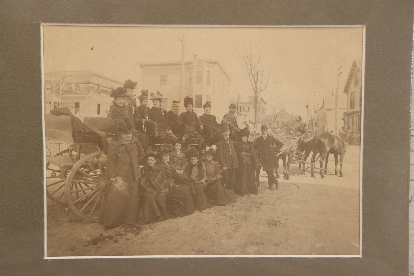 Lot 059 - Antique Boarded Photograph Of A Group Of Mostly Women Posing On A Long Horse Drawn Carriage. Shrink Wrapped With Mat