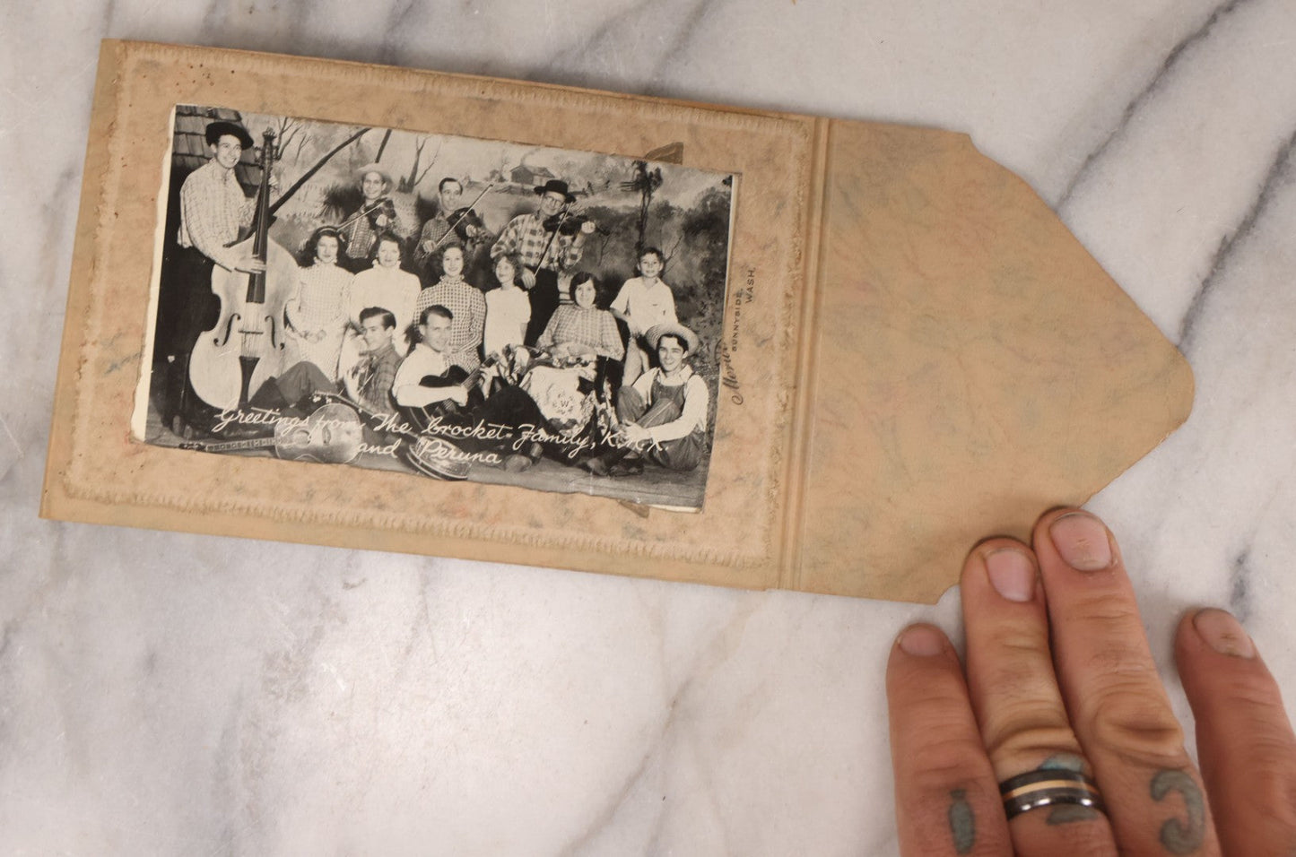 Lot 101 - Grouping Of 27 Vintage And Antique Photographs Including Many Portrait Photos, Two Photos Of Families Posing Outside, Tinted Photo Of Young Blonde Children, And Foldered Photo Of The Crockett Family Band