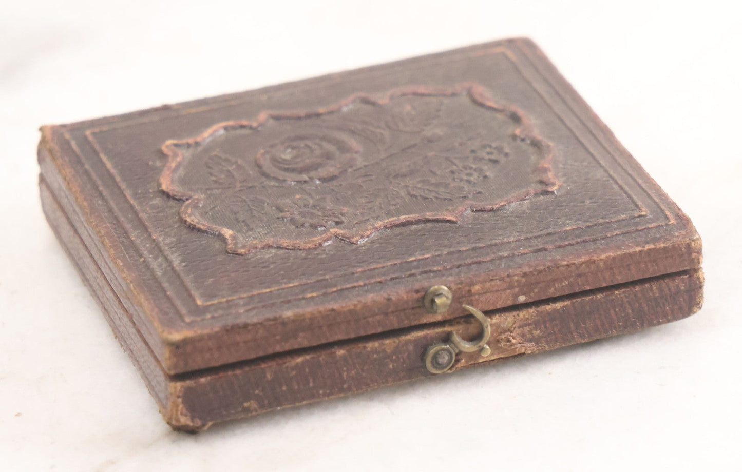 Lot 015 - Antique 1/9th Plate Daguerreotype Photograph Of Young Woman With Striking Eyes, White Collar, And Bonnet With Long Dark Lappets, In Full Intact Leatherette Union Case With Rose Motif