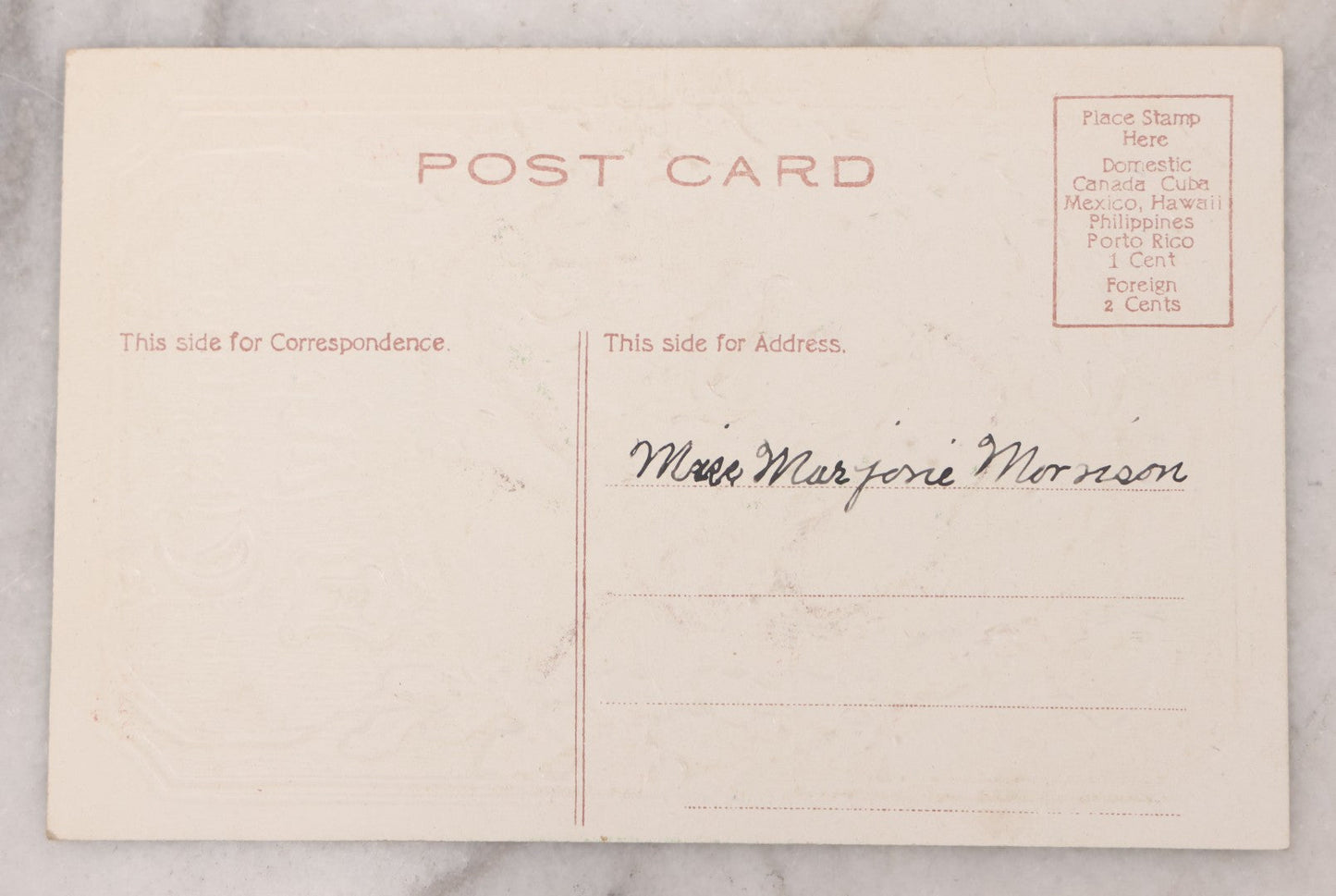 Lot 097 - Antique Embossed Christmas Postcard, "A Merry Christmas" Featuring Gold Saint Nick Santa With Mistletoe And Ribbon Border, Circa 1910