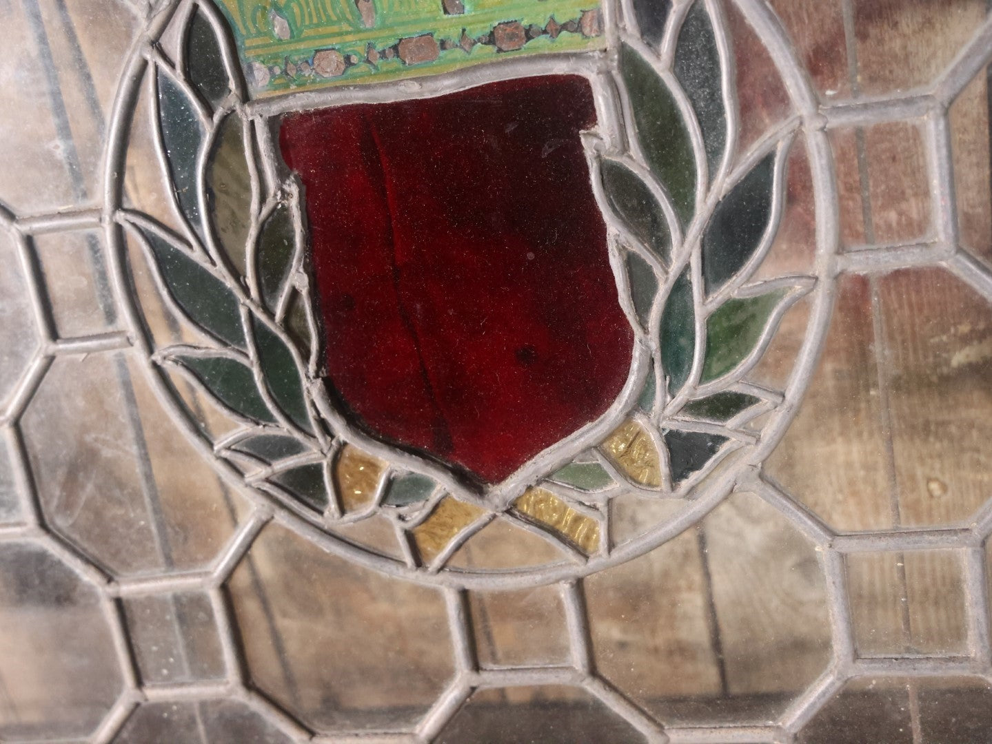 Antique Leaded Stained Glass Window With Red Shield At Center, Reinforced With Brackets, No Cracks, Ornate Green Panel, Wood Frame