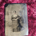Lot 114 - Tintype Of Black Woman, Slight Smile, Hands Holding The Other