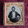 Lot 045 - Antique 6th Plate Ambrotype Photograph Of Middle Aged Man, Disheveled Hair, Beard, Gold Tinting On Watch Chain, In Half Leatherette Case