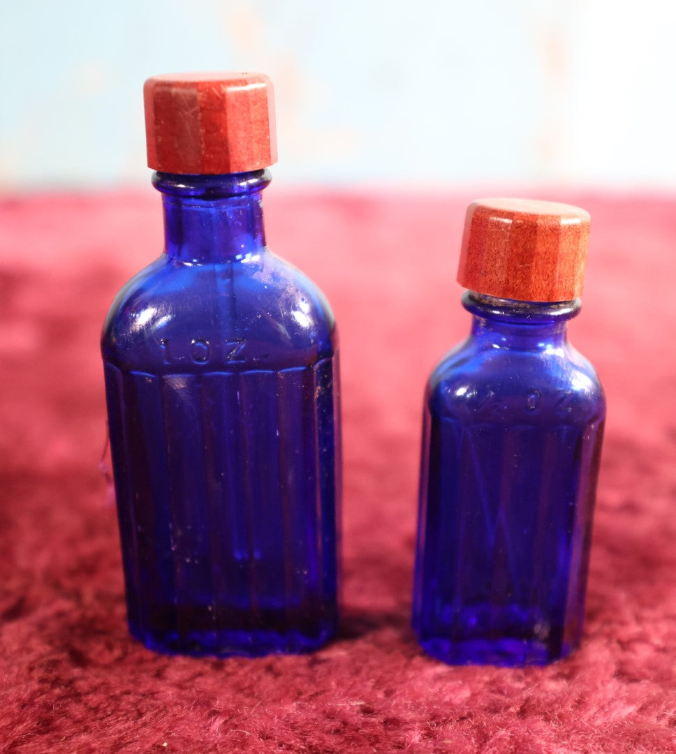 Lot 080 - Grouping Of Two Small Blue Poison Bottles With Red Caps