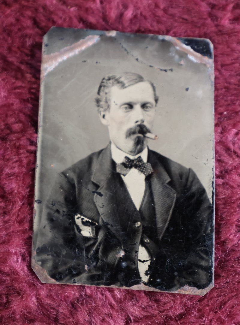 Lot 098 - Tintype Of Man In Bowtie Smoking Pipe