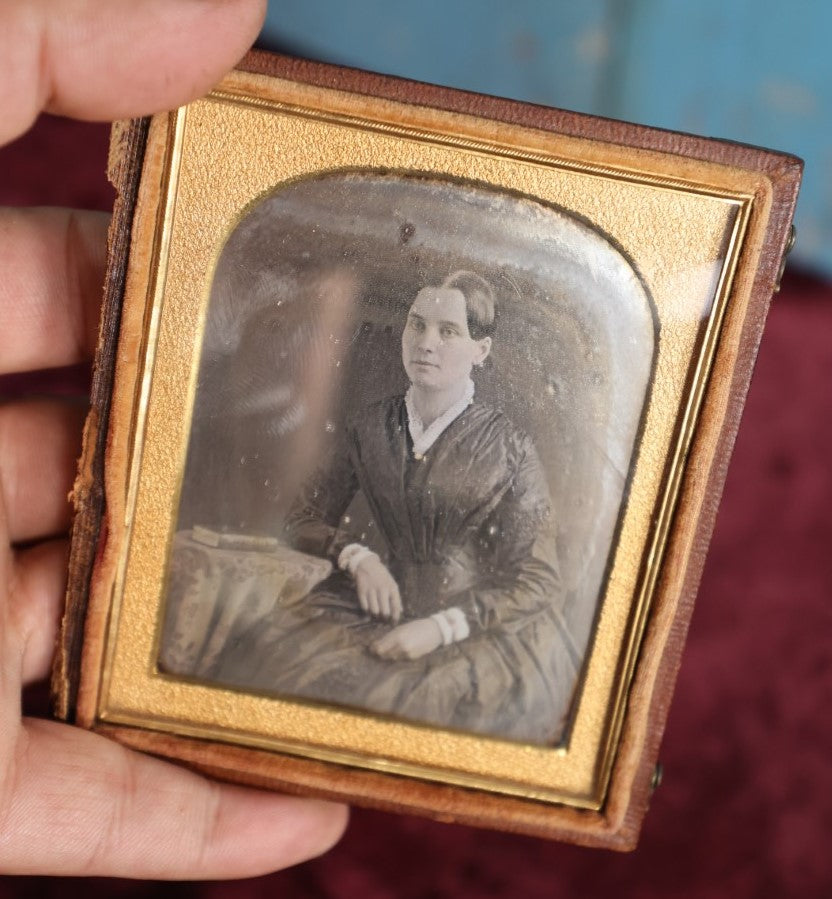 Lot 160 - Quarter Plate Daguerreotype Of Pretty Young Woman In Dress, Book On Table, Nice Half Leatherette Case With Floral Design