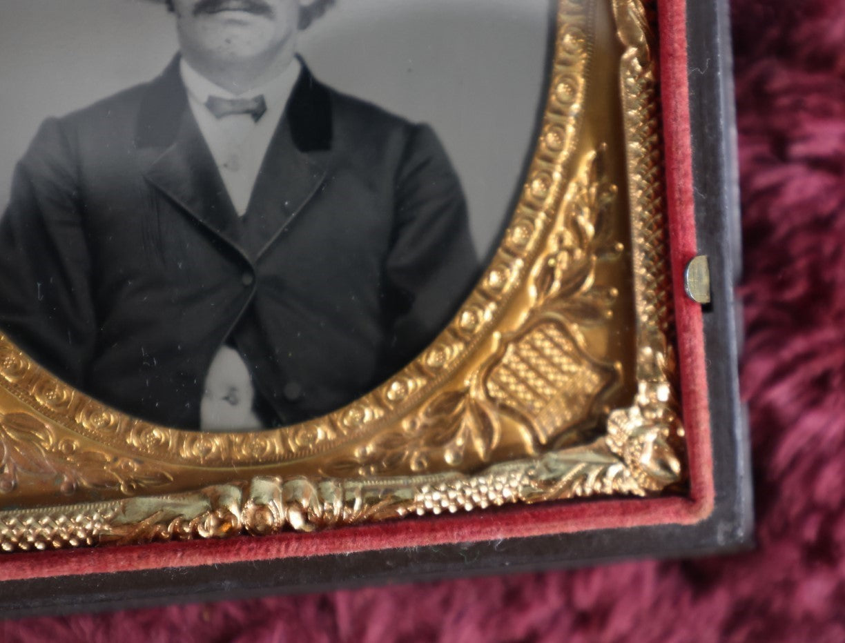 Lot 161 - Quarter Plate Ambrotype Of Handsom Young Man With Interesting Look, Mustache, Unusual Headroom Framing, Near Perfect Condition Large Size Thermoplastic Case With Lay Flat Hinge, Patriotic Shield Brass Mat