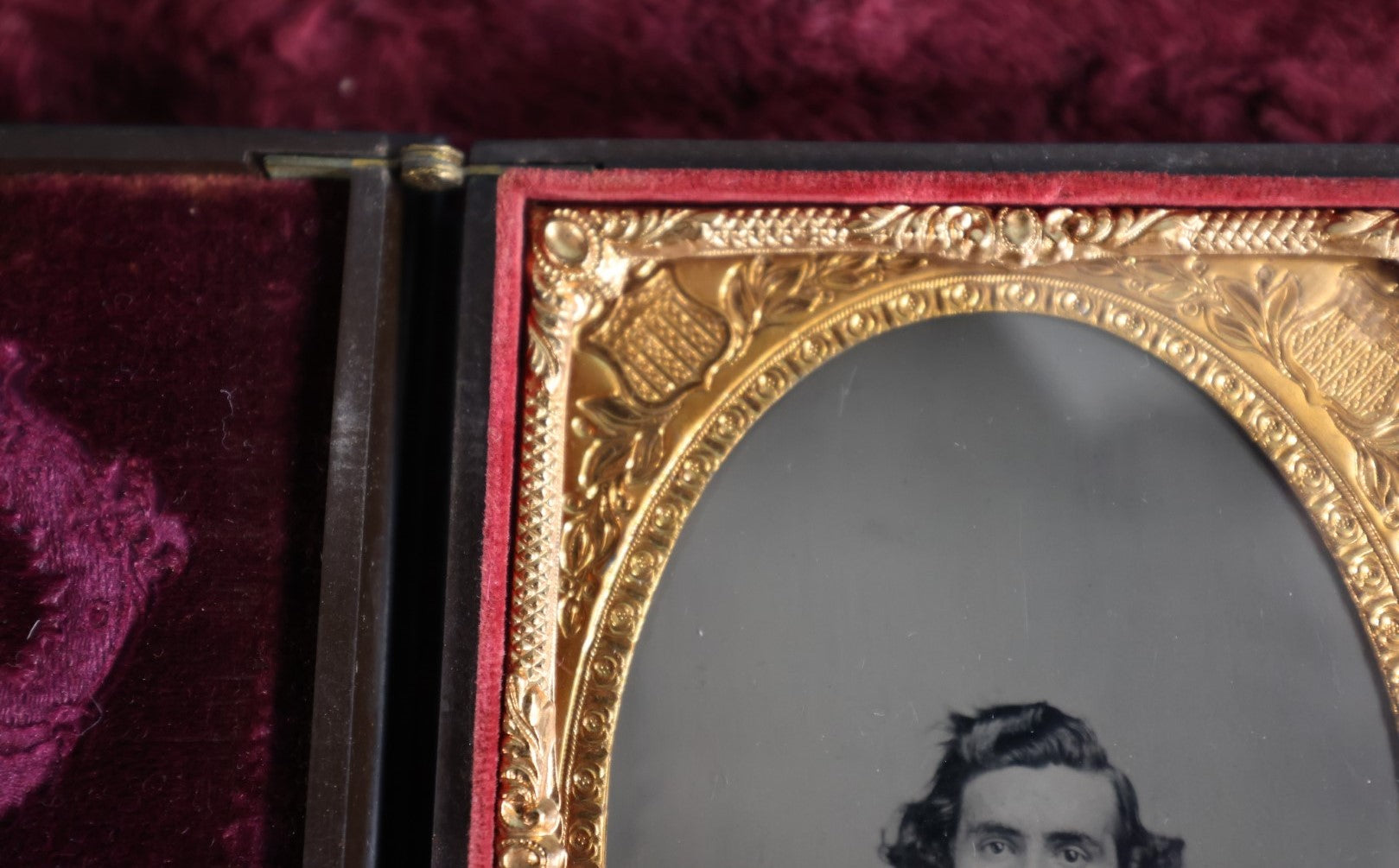 Lot 161 - Quarter Plate Ambrotype Of Handsom Young Man With Interesting Look, Mustache, Unusual Headroom Framing, Near Perfect Condition Large Size Thermoplastic Case With Lay Flat Hinge, Patriotic Shield Brass Mat