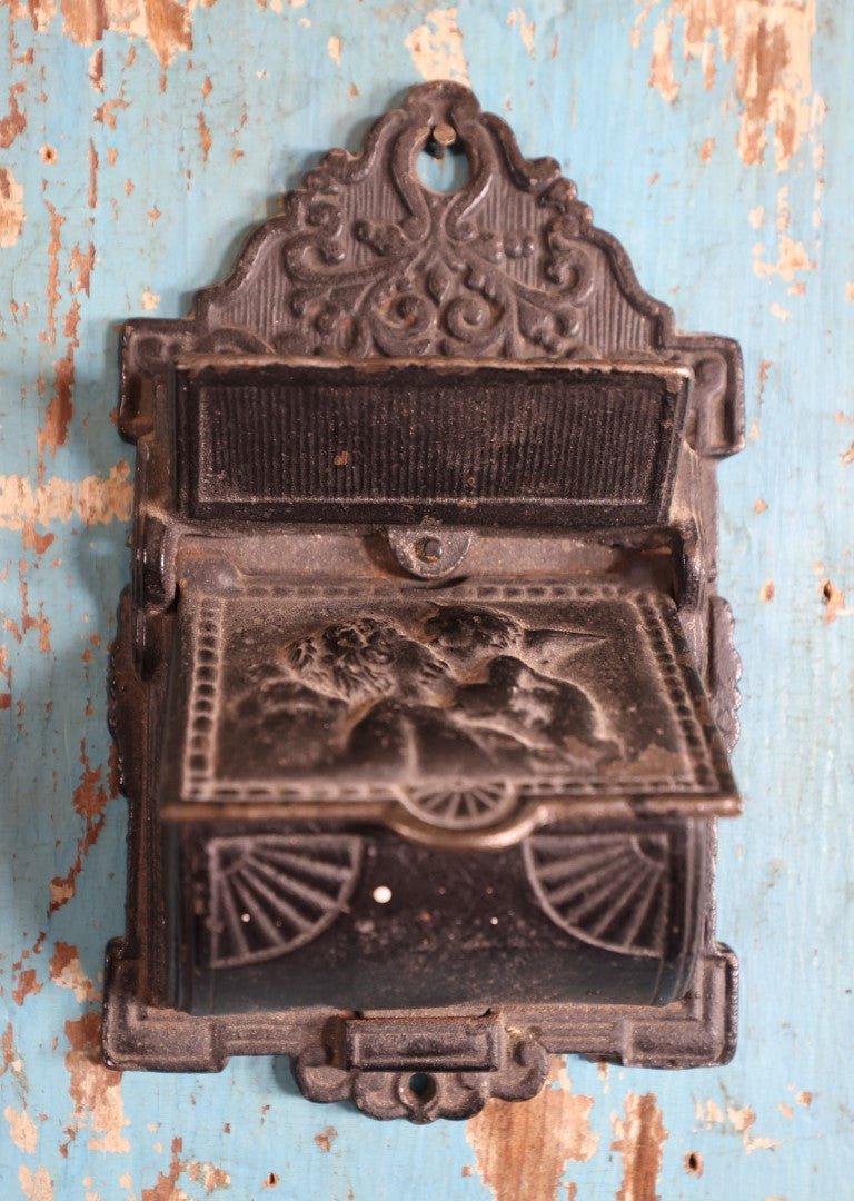 Lot 015 - Antique Venus And Cupid Cast Iron Match Box With Hinged Lid, Match Strike, Marked V.M. Co.