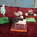 Lot 027 - Grouping Of Three Vintage Dia De Los Muertos Day Of The Dead Mexican Folk Art Skeleton Statues, Camera Man, Band, Etc, One Missing Head