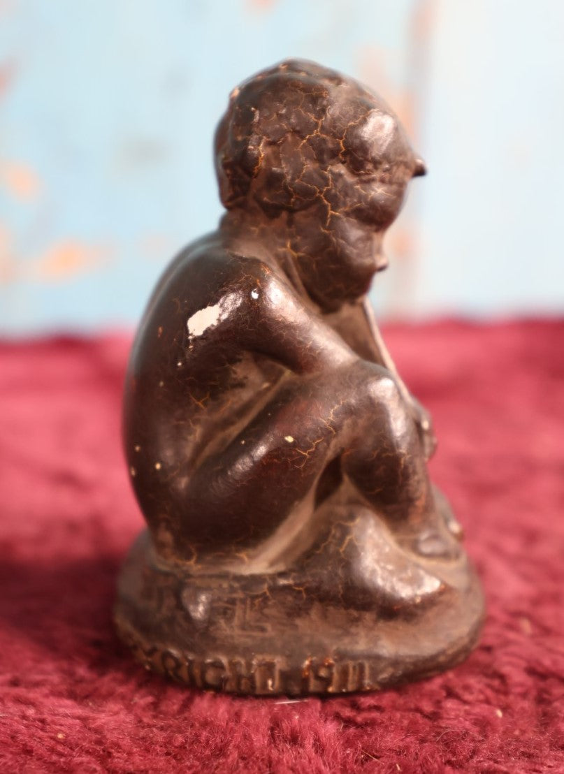 Lot 053 - Antique Chalkware Baby Pan Statue, Dated 1911