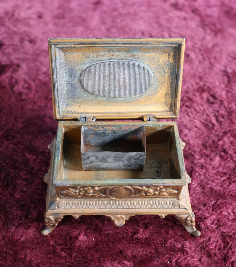 Lot 031 - Antique Pot Metal Match Safe With Cupid Motif, Ornate With Match Strike And Small Box On The Inside, Feet, Etc