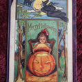 Lot 067 - Antique Merry Halloween Postcard With Girl With Jack O-Lantern, Witch Flying Above With Cat Familiar, Note Losses, Bends, Damage