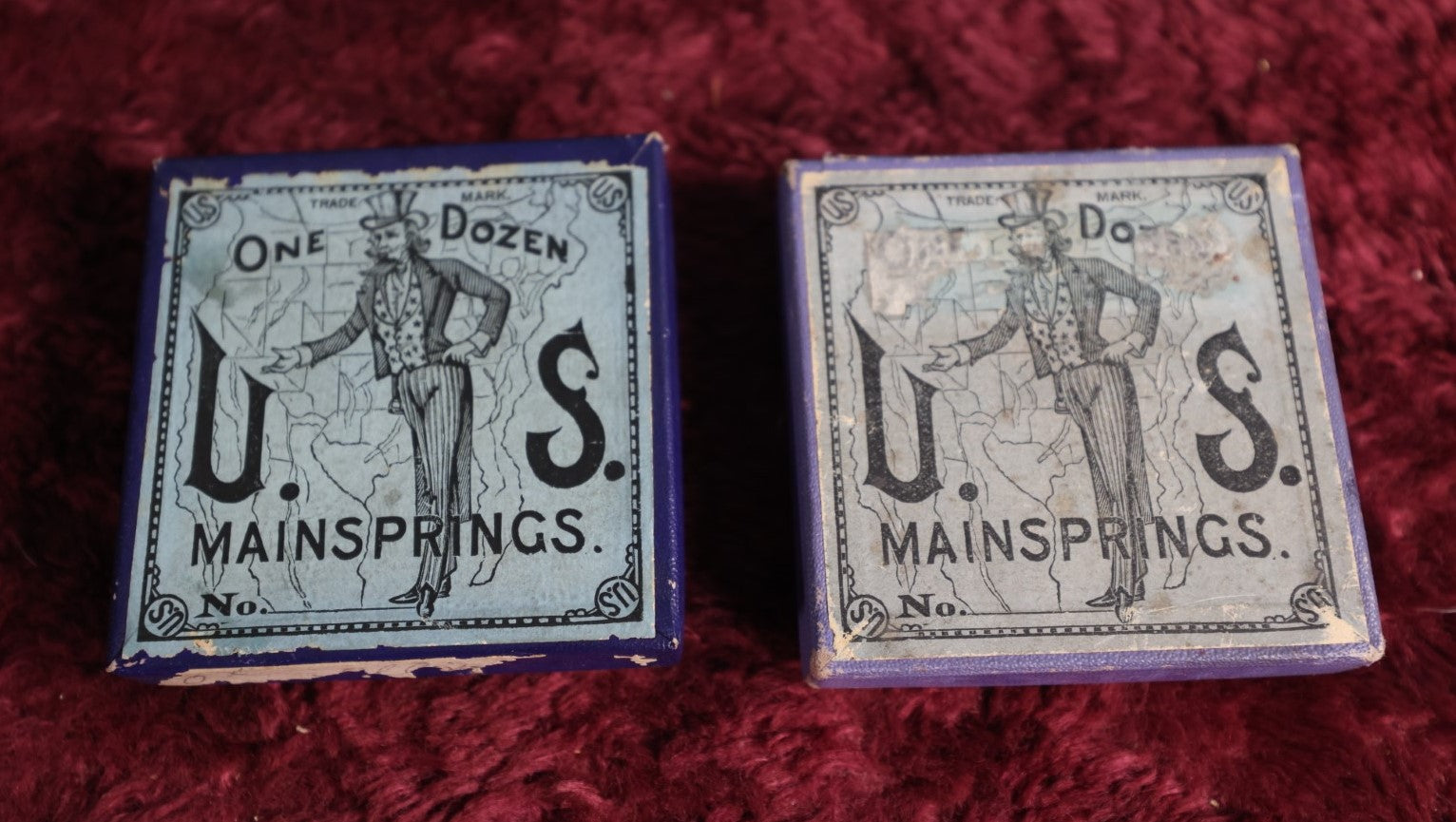 Lot 069 - Pair Of Uncle Sam Watch Main Springs Boxes With Contents