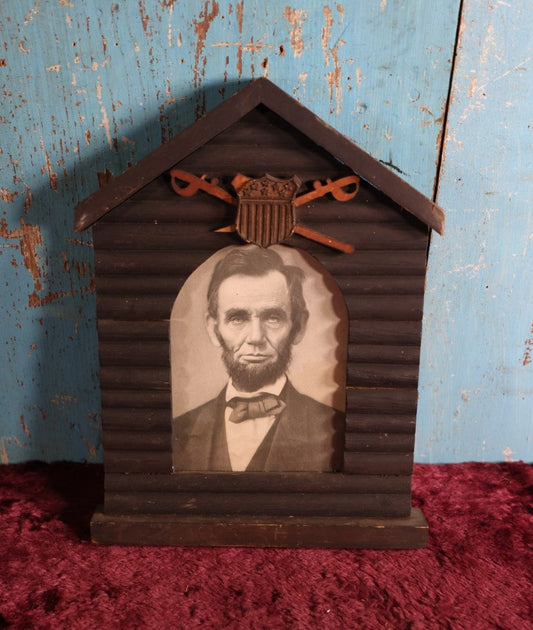 Lot 079 - Antique Print Of President Abraham Lincoln In Hand Made Log Cabin Frame With Patriotic Shield, Swords, Likely Grand Army Of The Republic Related, Note Losses To Wood