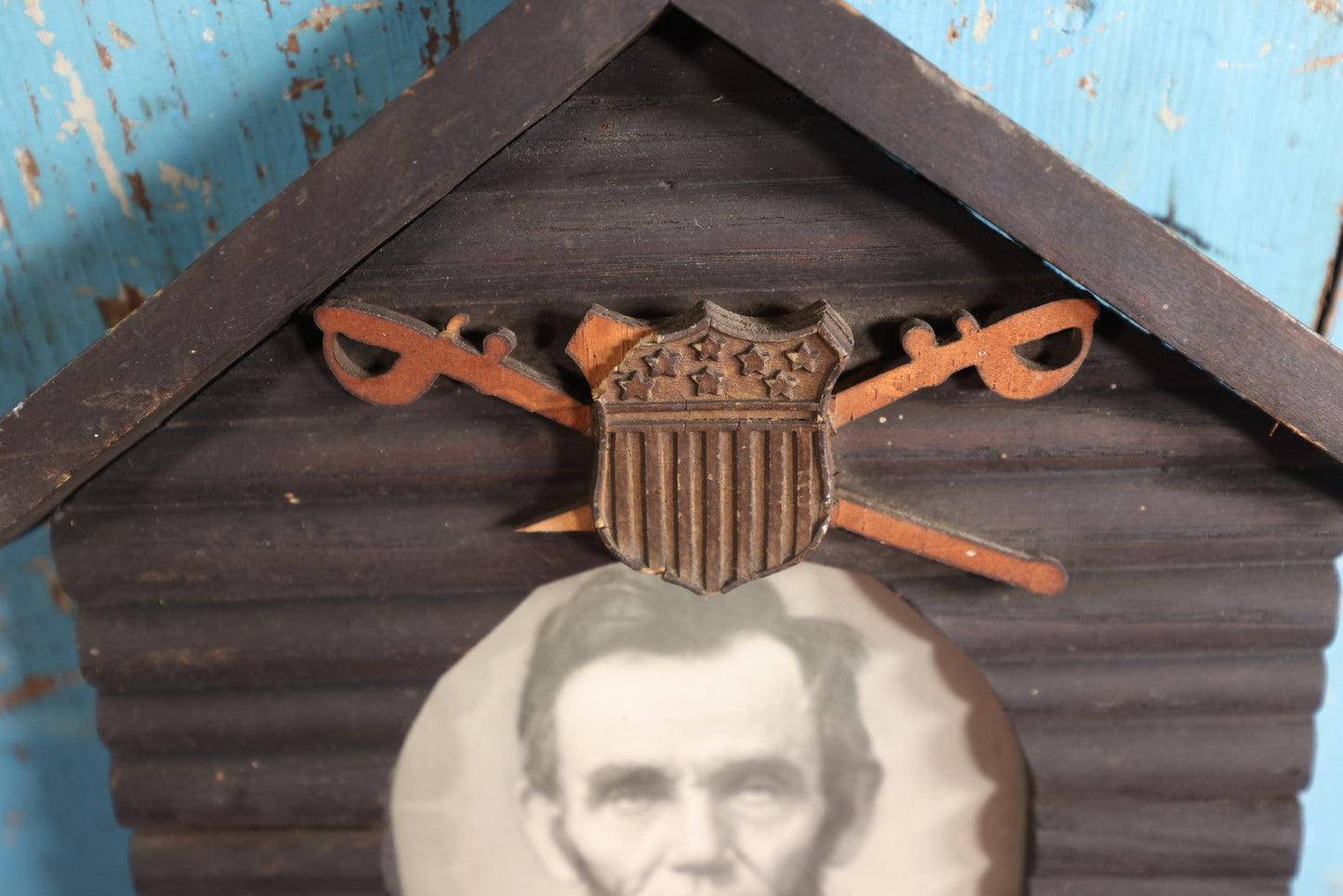 Lot 079 - Antique Print Of President Abraham Lincoln In Hand Made Log Cabin Frame With Patriotic Shield, Swords, Likely Grand Army Of The Republic Related, Note Losses To Wood