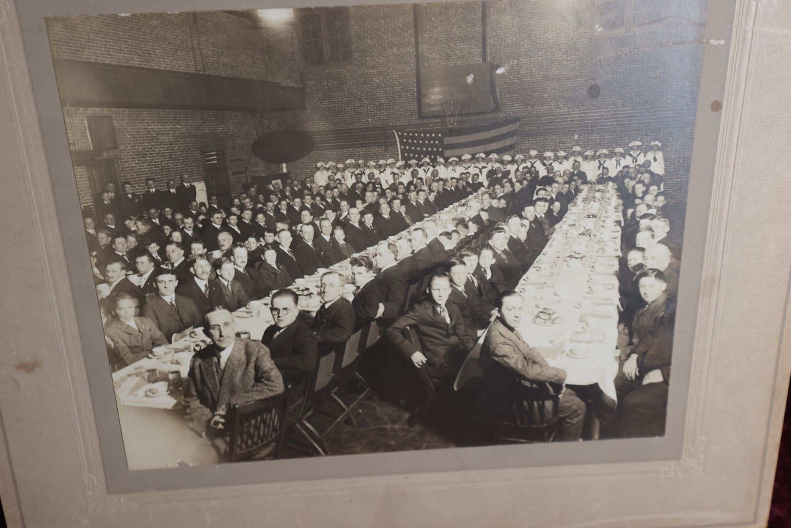 Lot 081 - Antique Boarded Group Photo Of Many Men, Young Boys, Flag In Background