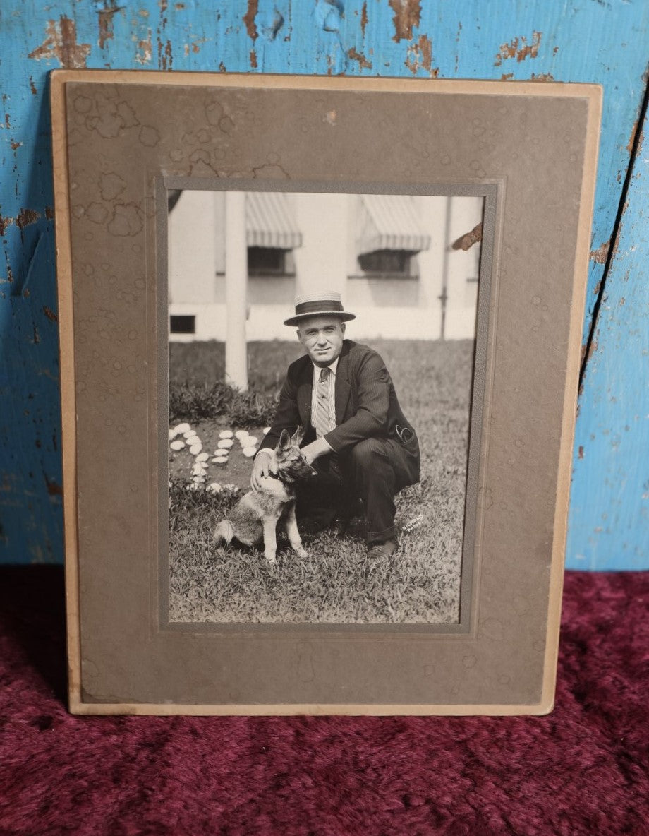 Lot 084 - Antique Boarded Photo Of Man In Hat With German Shepherd Puppy