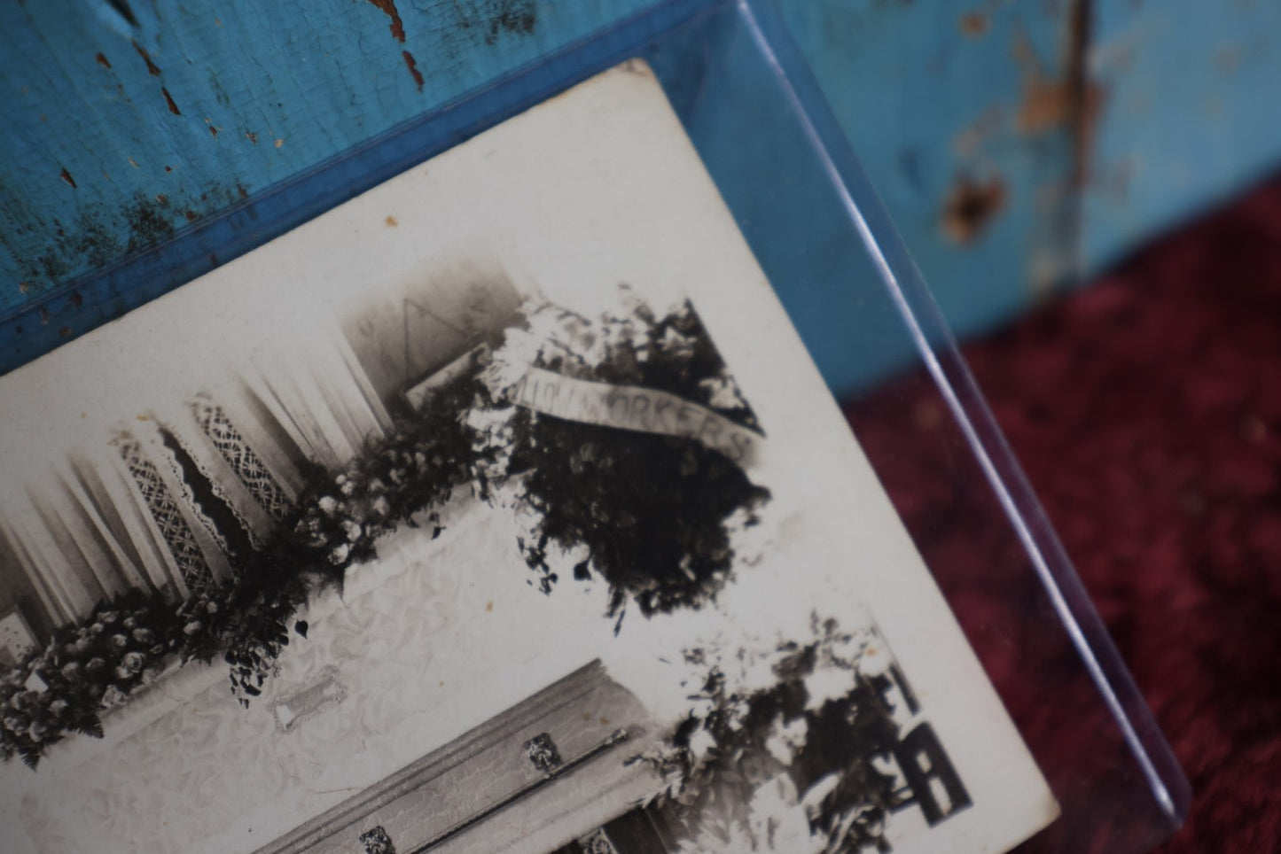 Lot 086 - Antique Real Photo Postcard Rppc Of Man In Coffin, Flower Wreath Says Pillow Workers (?)