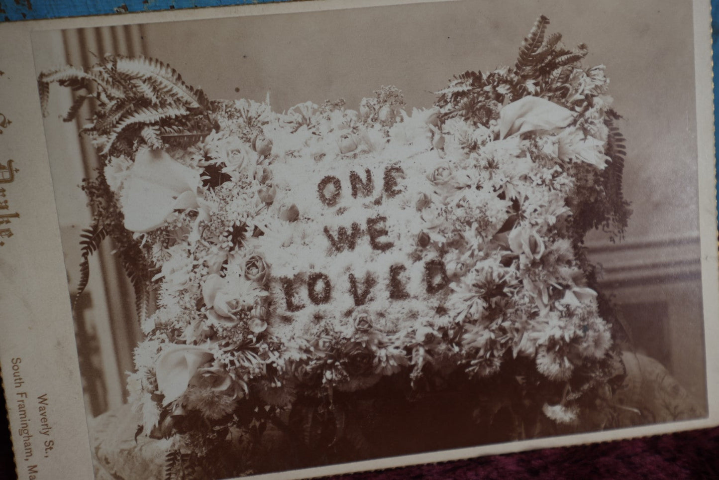 Lot 094 - Anitque Cabinet Card Photograph Of Funeral Flowers Memorial "One We Loved" In Pillow Shape, Photographed By H.S. Drake, South Framingham, Massachusetts