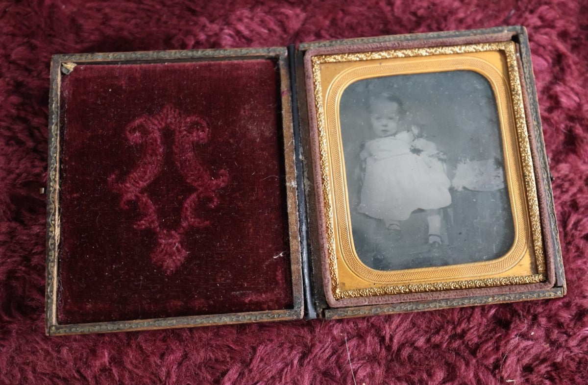 Lot 131 - Antique Ambrotype Of Young Baby Girl With Fluffy Object Next To Her - Possibly Cat - In Full Leatherette Union Case, Repaired Hinge, 1/6Th Plate