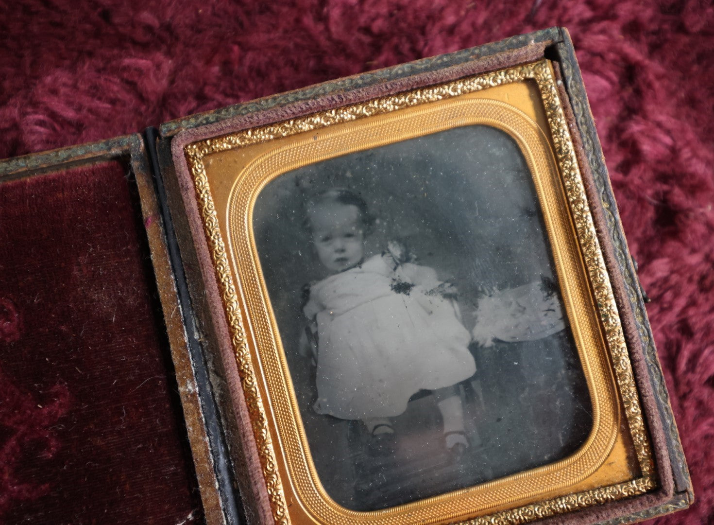 Lot 131 - Antique Ambrotype Of Young Baby Girl With Fluffy Object Next To Her - Possibly Cat - In Full Leatherette Union Case, Repaired Hinge, 1/6Th Plate