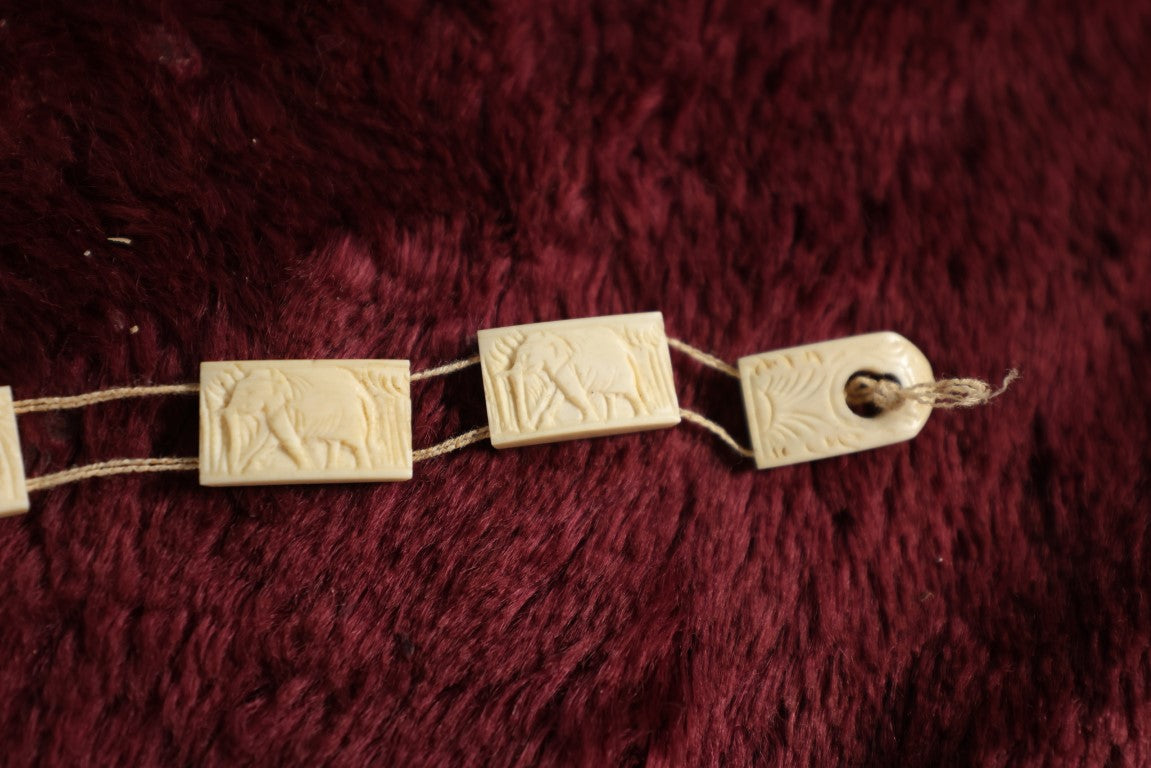 Lot 052 - Five Piece Grouping Of Carved Bone And Antler Jewelry, Including Clip On Earrings, Carbed Bone Bracelet With Elephant Motif, Pair Of Hand Painted Antler Stem Brooches