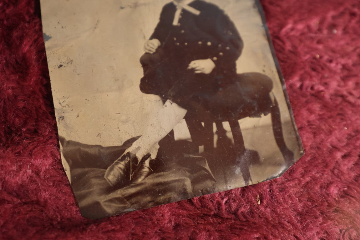 Lot 120 - Quarter Plate Tintype Of Young Boy Sitting On Ottomon, Dents, Wear