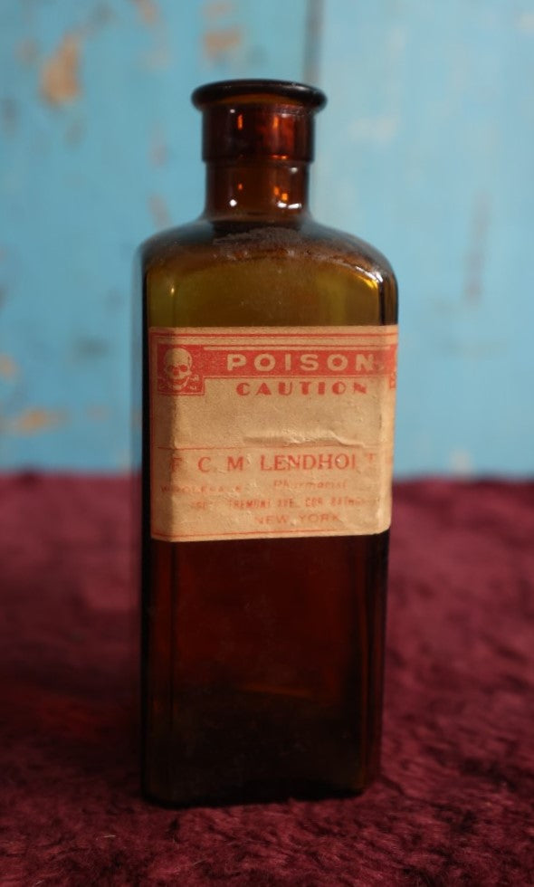 Lot 132 - Antique Amber Glass Bottle With Poison Label From F.C.M Lendholt, Skull And Crossbones, Label May Have Been Added Later