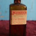 Lot 132 - Antique Amber Glass Bottle With Poison Label From F.C.M Lendholt, Skull And Crossbones, Label May Have Been Added Later