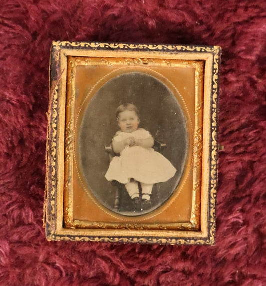 Lot 031 - Antique 1/9th Plate Ambrotype Photograph Of Cheeky Baby, Motion Blur On Face, Clasping Hands, Partial Leatherette Union Case