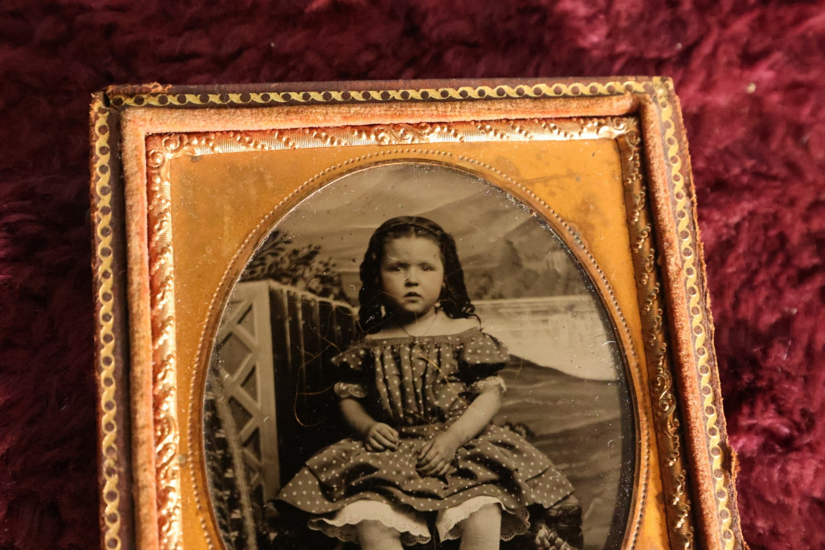 Lot 069 - Antique 1/6th Plate Ambrotype Photograph Of Young Girl In Polka Dot Dress, Outdoor Studio Scene, In Half Leatherette Case