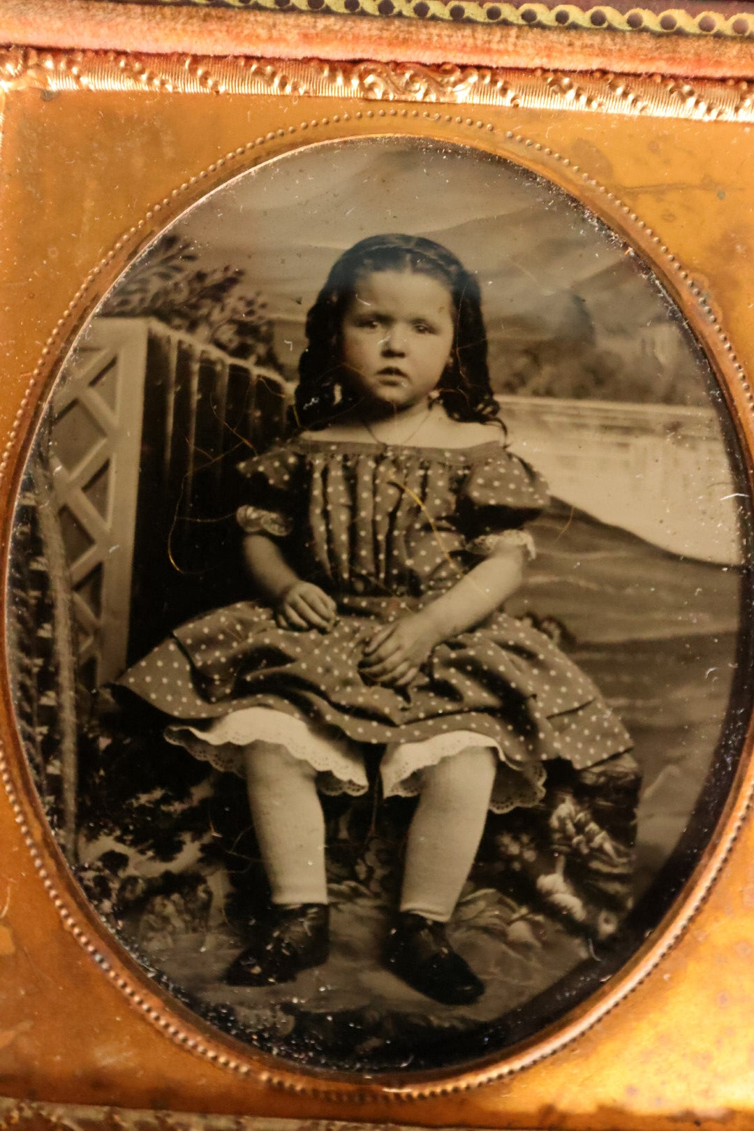 Lot 069 - Antique 1/6th Plate Ambrotype Photograph Of Young Girl In Polka Dot Dress, Outdoor Studio Scene, In Half Leatherette Case