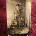Lot 113 - Tintype - Young Man Wearing Bowler Cap, Leaning On Adirondack Branch Chair, Holding Swagger Stick Cane