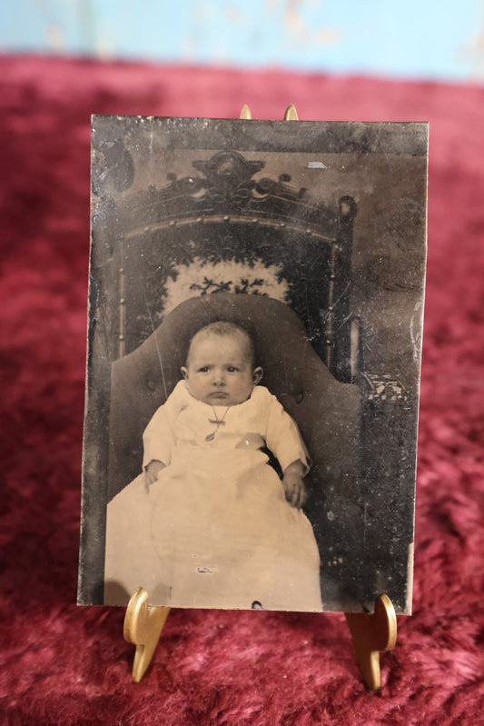 Lot 116 - Tintype - Scrunched Up Looking Little Baby In Chair, Wearing Necklace, Looking Grumpy