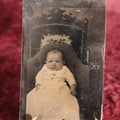 Lot 116 - Tintype - Scrunched Up Looking Little Baby In Chair, Wearing Necklace, Looking Grumpy