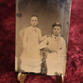 Lot 119 - Tintype - Two Young Girls, One Standing With Hand On Shoulder Of Other Girl Who Is Seated, Both Dressed In White