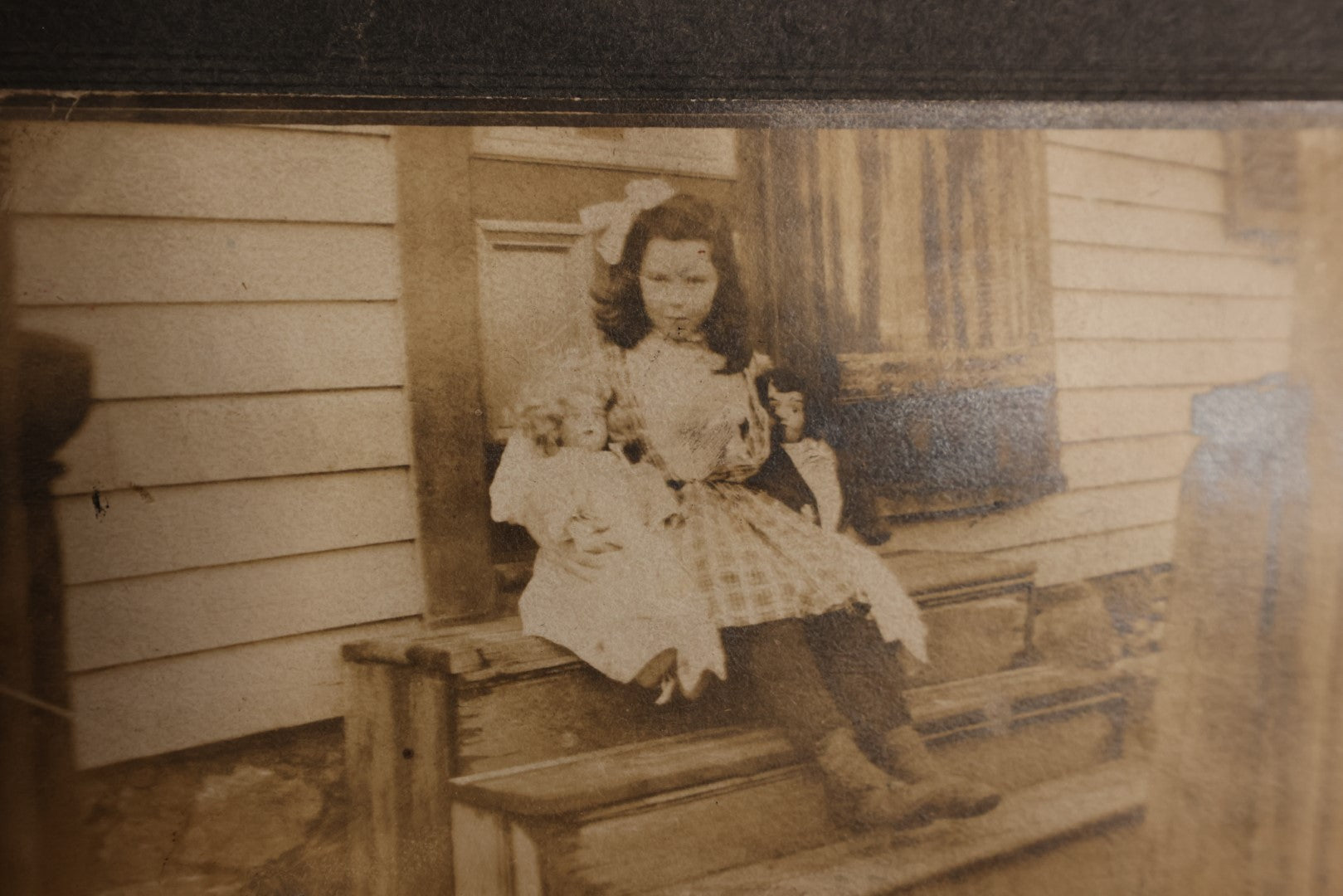 Lot 133 - Small Boarded Photo - Little Girl Sitting On Stoop Holding Two Dolls