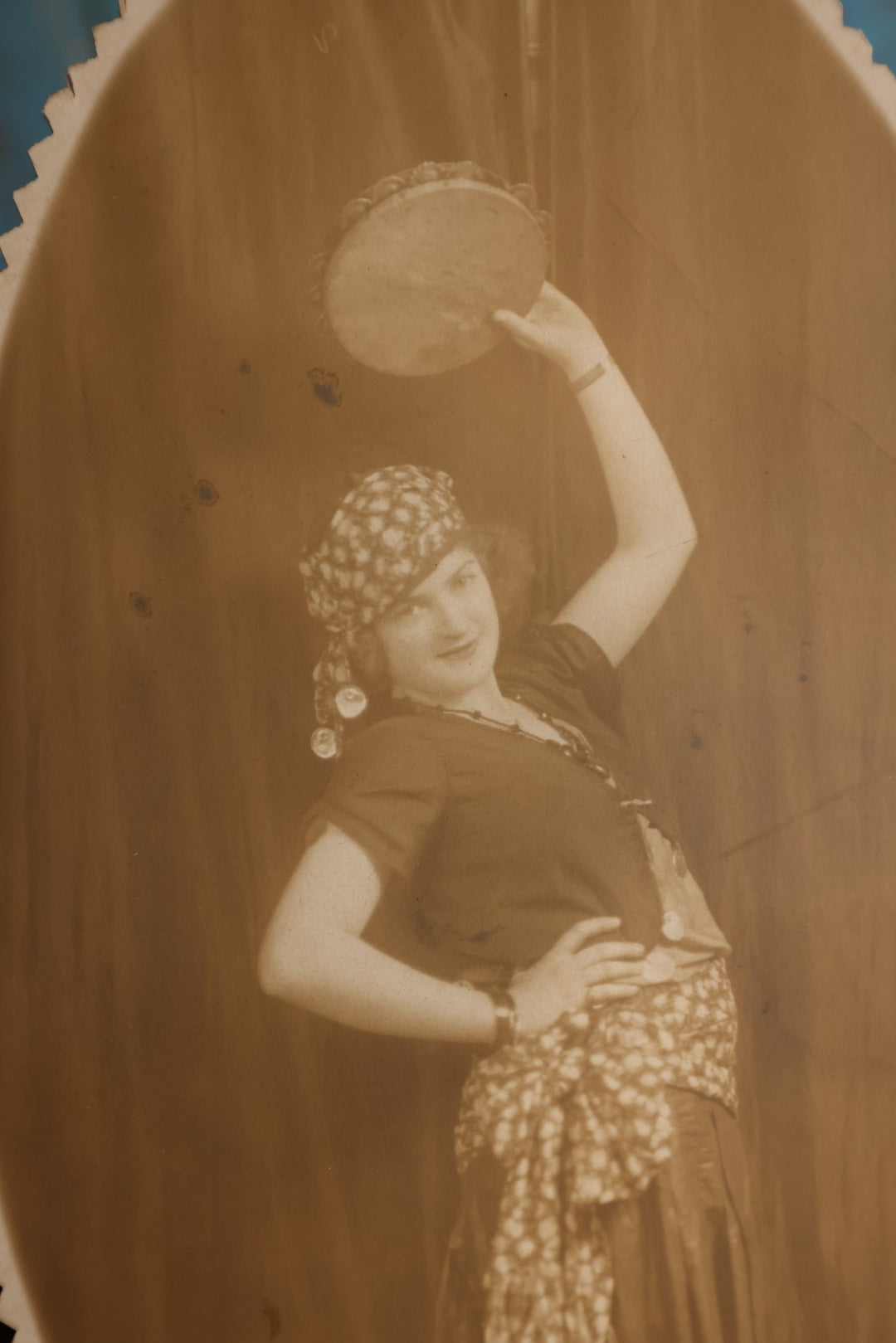 Lot 135 - Small Boarded Photo - Oval, Spikey Cut Edge Of Gypsy Dressed Woman With Tambourine